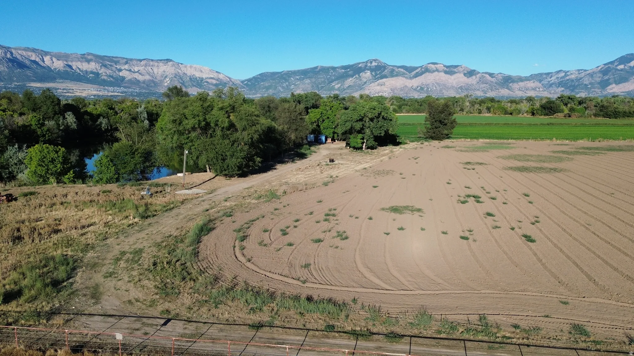 Expansive tilled agricultural land with distant mountain range