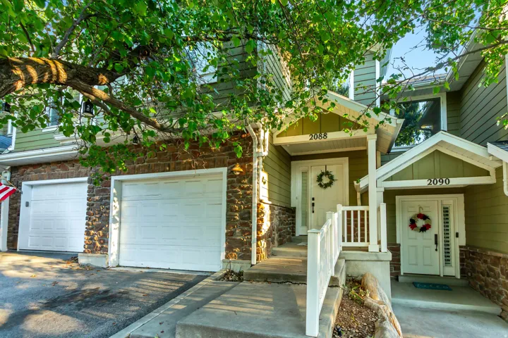 Multi-level townhouse exterior featuring stone veneer and horizontal siding