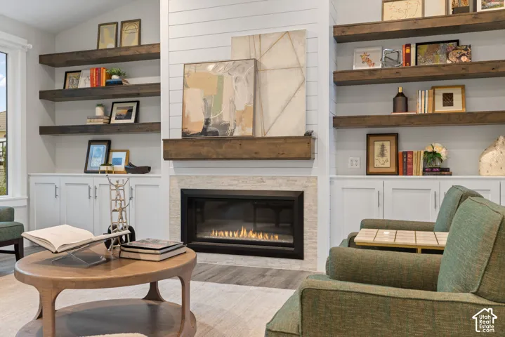 Gas fireplace with a tile surround and wood mantel