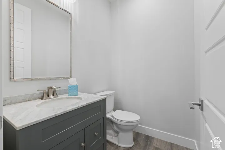 Vanity with stone countertop, undermount sink, and brushed nickel faucet