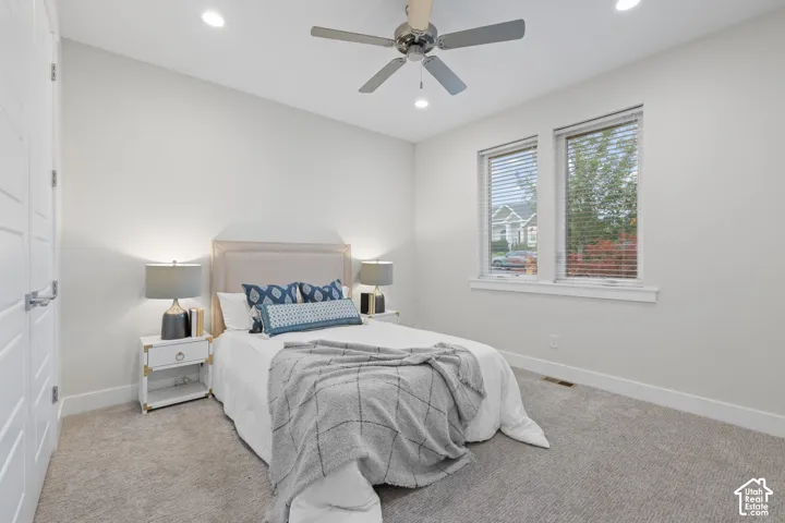 Recessed lighting, ceiling fan, twin windows, wall-to-wall carpeting, and a flat-panel door