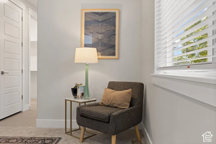 White paneled interior doors, light gray wall finishes, and a window with horizontal blinds