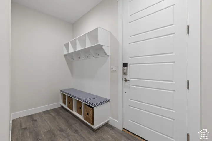 Built-in mudroom bench with storage cubbies and upper shelving with coat hooks