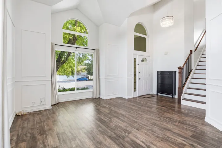 Vaulted ceilings, wood-finish flooring, and arched windows