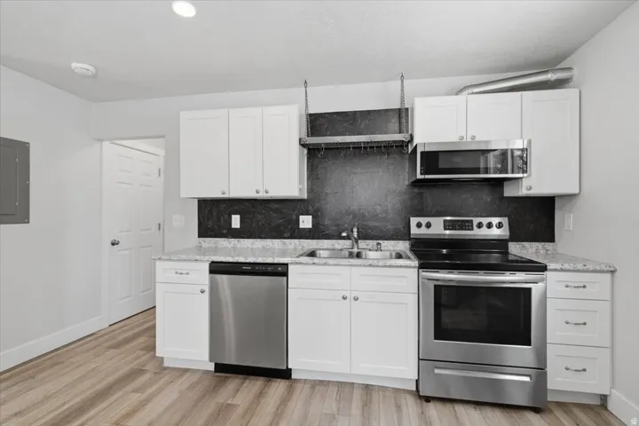 Bright kitchen with dishwasher, electric range and oven, built in microwave with exterior venting.