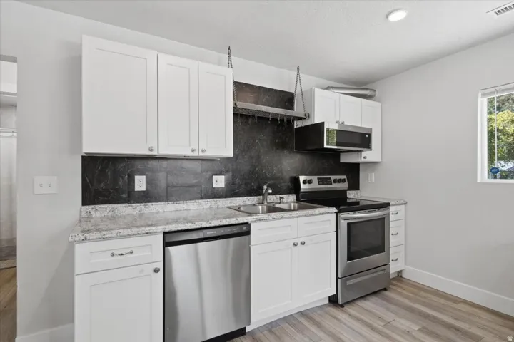 Bright kitchen with dishwasher, electric range and oven, built in microwave with exterior venting.
