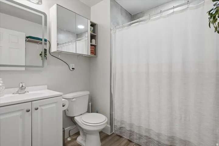 White vanity with an integrated sink and chrome faucet and full bath.