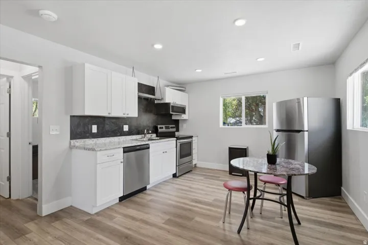 Bright kitchen with dishwasher, electric range and oven, built in microwave with exterior venting. Refrigerator included.