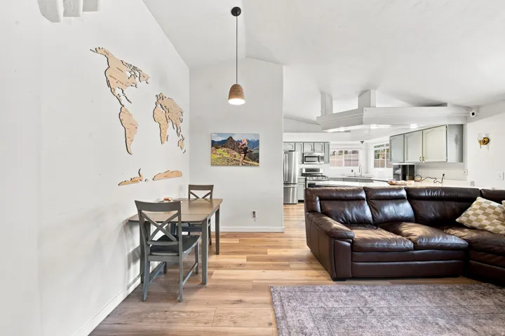 Vaulted ceiling, recessed lighting, wood-finish flooring, built-in shelving, pendant light fixture