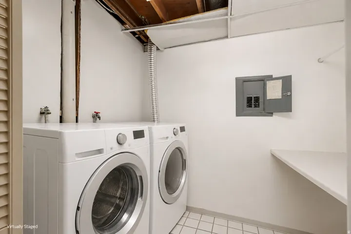 White tile flooring, built-in shelving, and a wall-mounted electrical panel