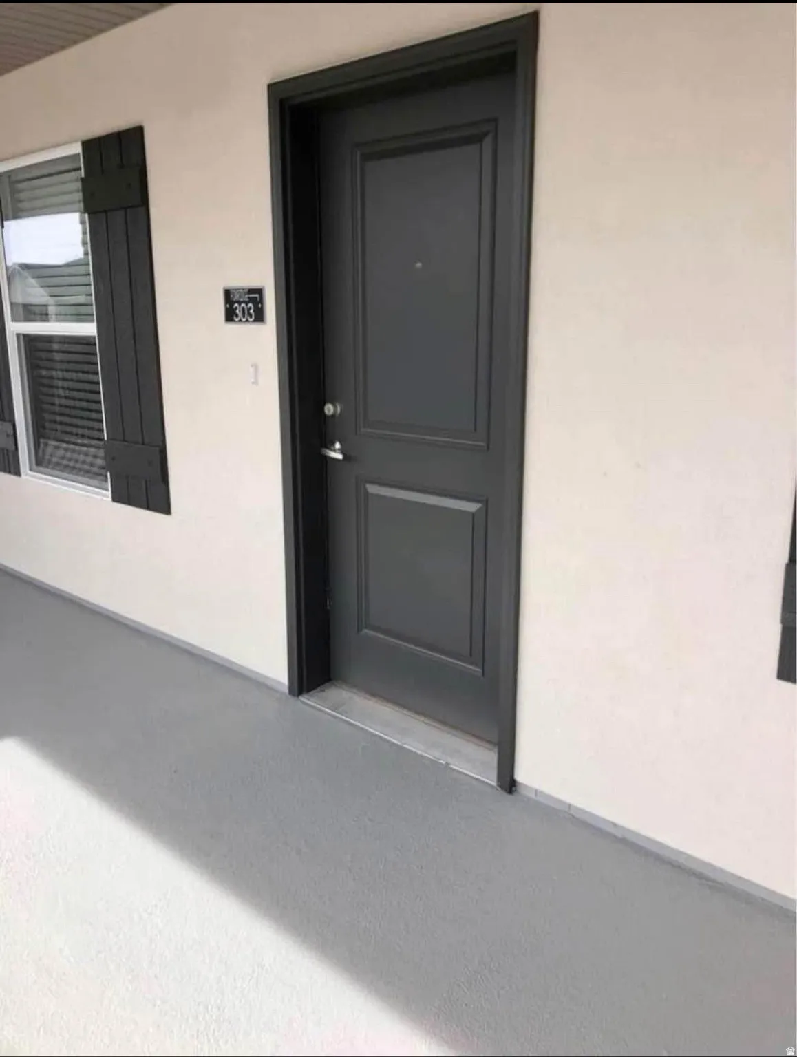 Entry door with decorative paneling and contrasting dark trim