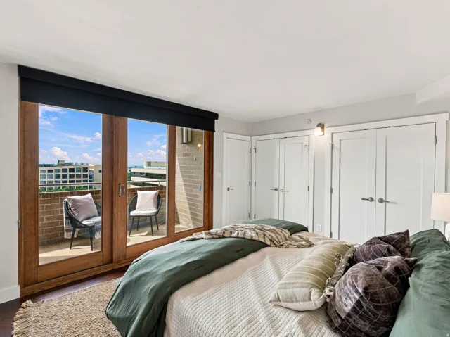 Wood-framed glass doors open to a private balcony