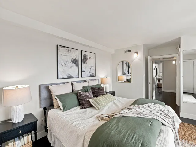 Light-toned walls, dark wood-finish flooring, and recessed ceiling lighting