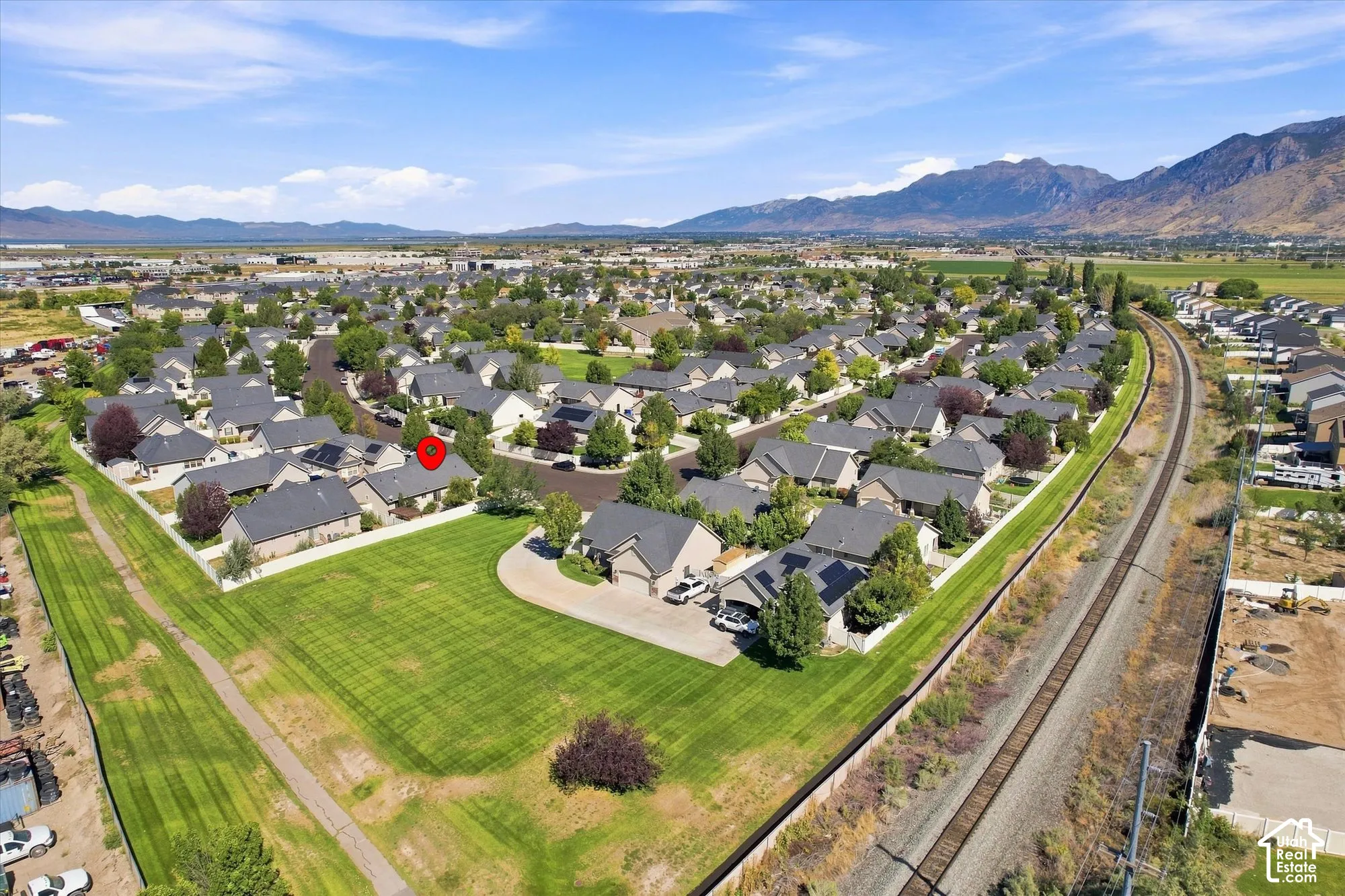 Residential neighborhood featuring single-story homes, established landscaping, and mountain backdrops