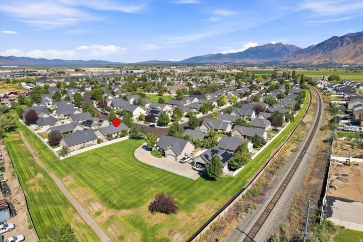 Residential neighborhood featuring single-story homes, established landscaping, and mountain backdrops