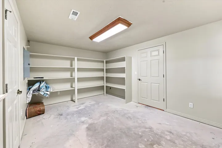 Built-in shelving for ample storage, smooth ceiling, and flush-mount lighting