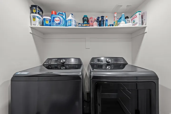 Dedicated utility area featuring a built-in white shelf and neutral wall paint