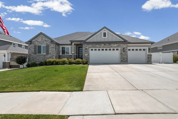 Stone and siding exterior with a pitched roofline