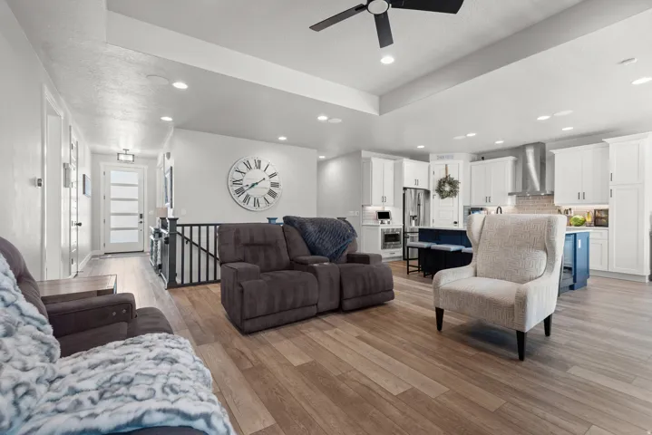 Open-concept living space featuring wood-finish flooring, recessed lighting, and a contemporary ceiling fan
