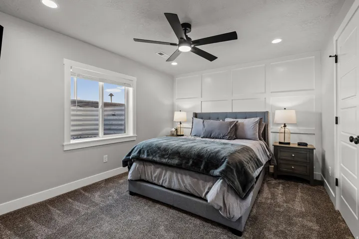 Bedroom featuring accent wall paneling, recessed lighting, and a contemporary ceiling fan