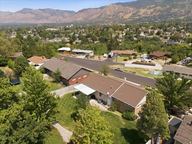 Expansive residential area featuring mature trees and mountain scenery
