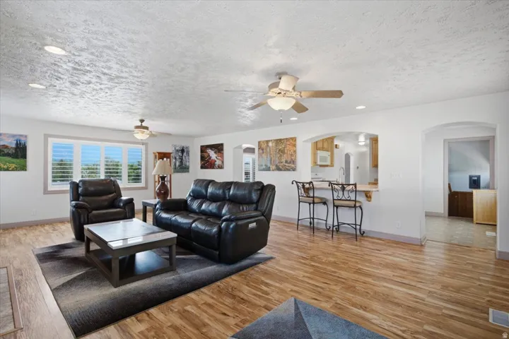 Wood-finish flooring, recessed lighting, and ceiling fans