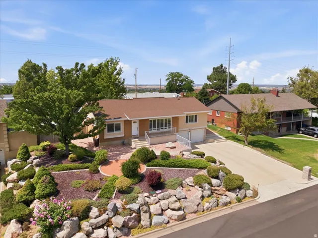Single-story residence featuring a brown shingle roof, integrated two-car garage, and a concrete driveway