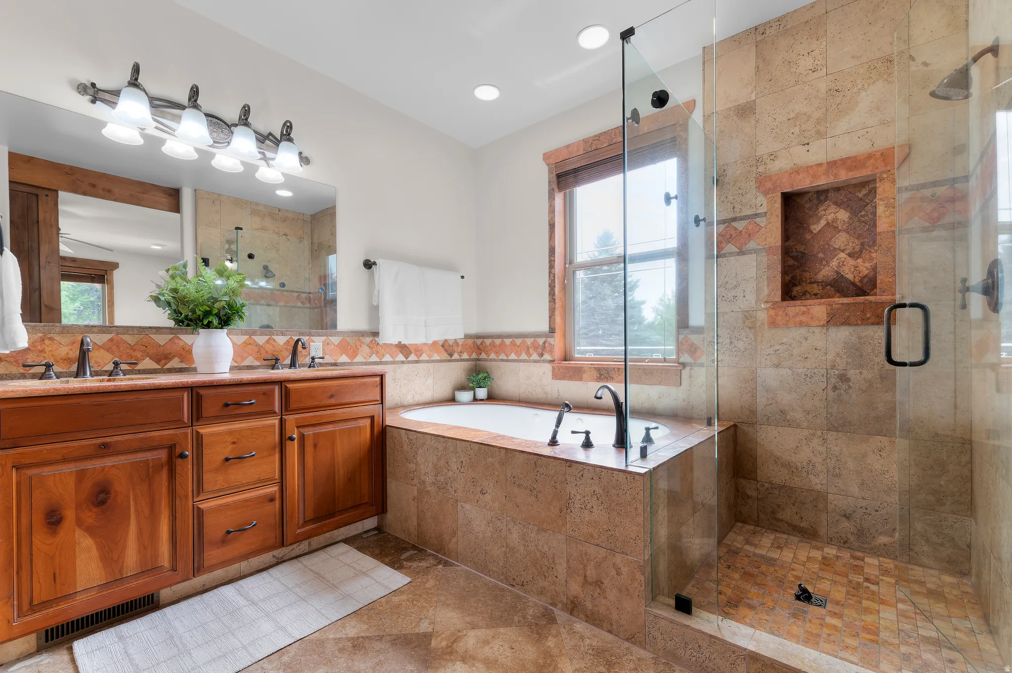 Dual vanity with wood cabinetry and undermount sinks