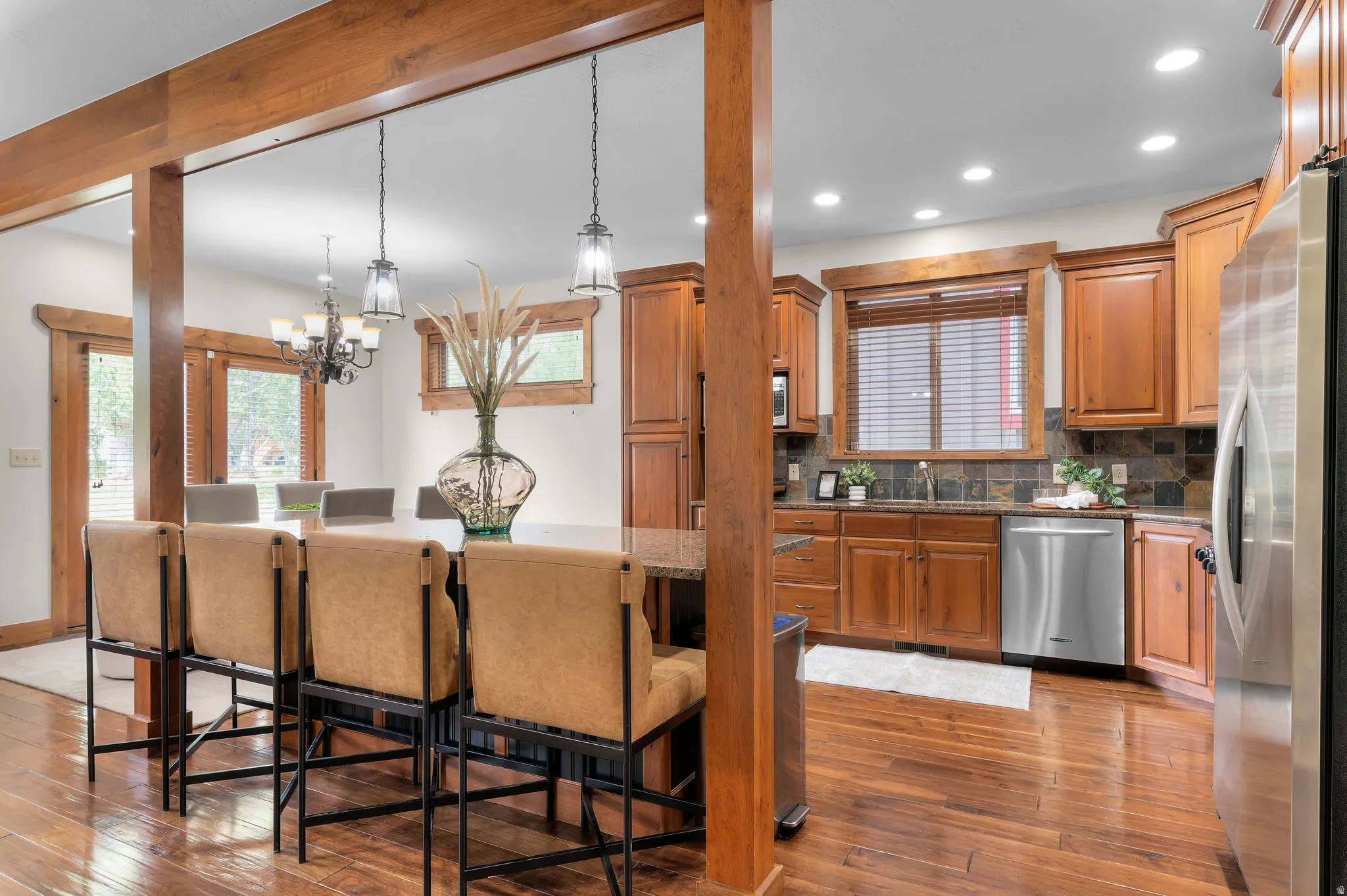 Open-concept kitchen featuring wood-finish flooring, recessed lighting, and a kitchen island with pendant lighting