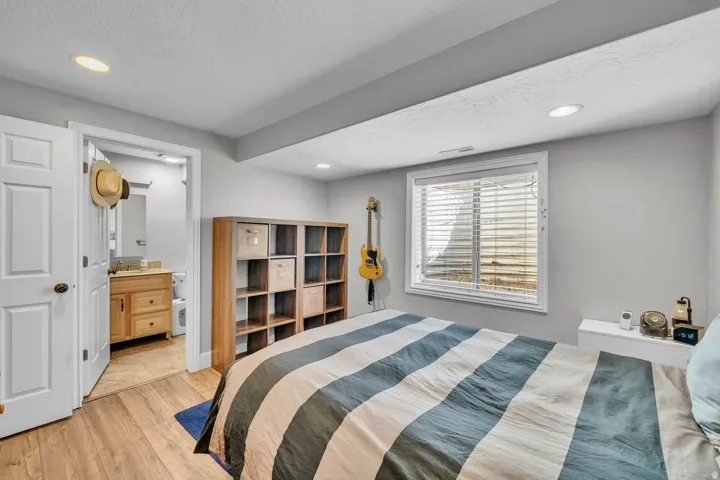Wood-finish flooring, recessed lighting, and a white framed window
