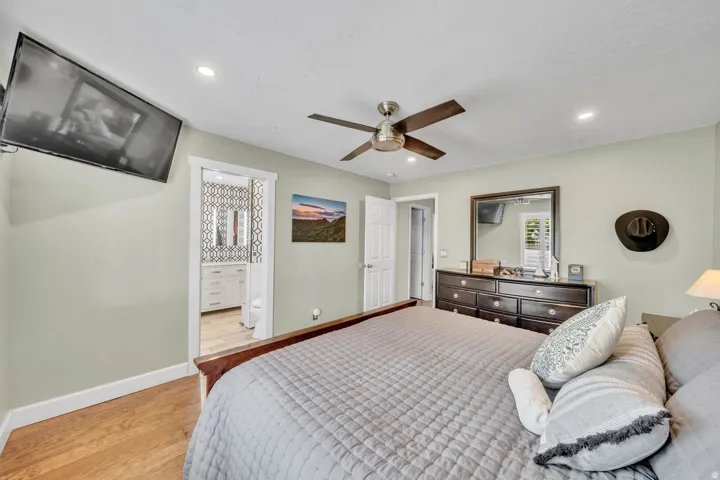 Wood-finish flooring, recessed lighting, and a ceiling fan with light fixture