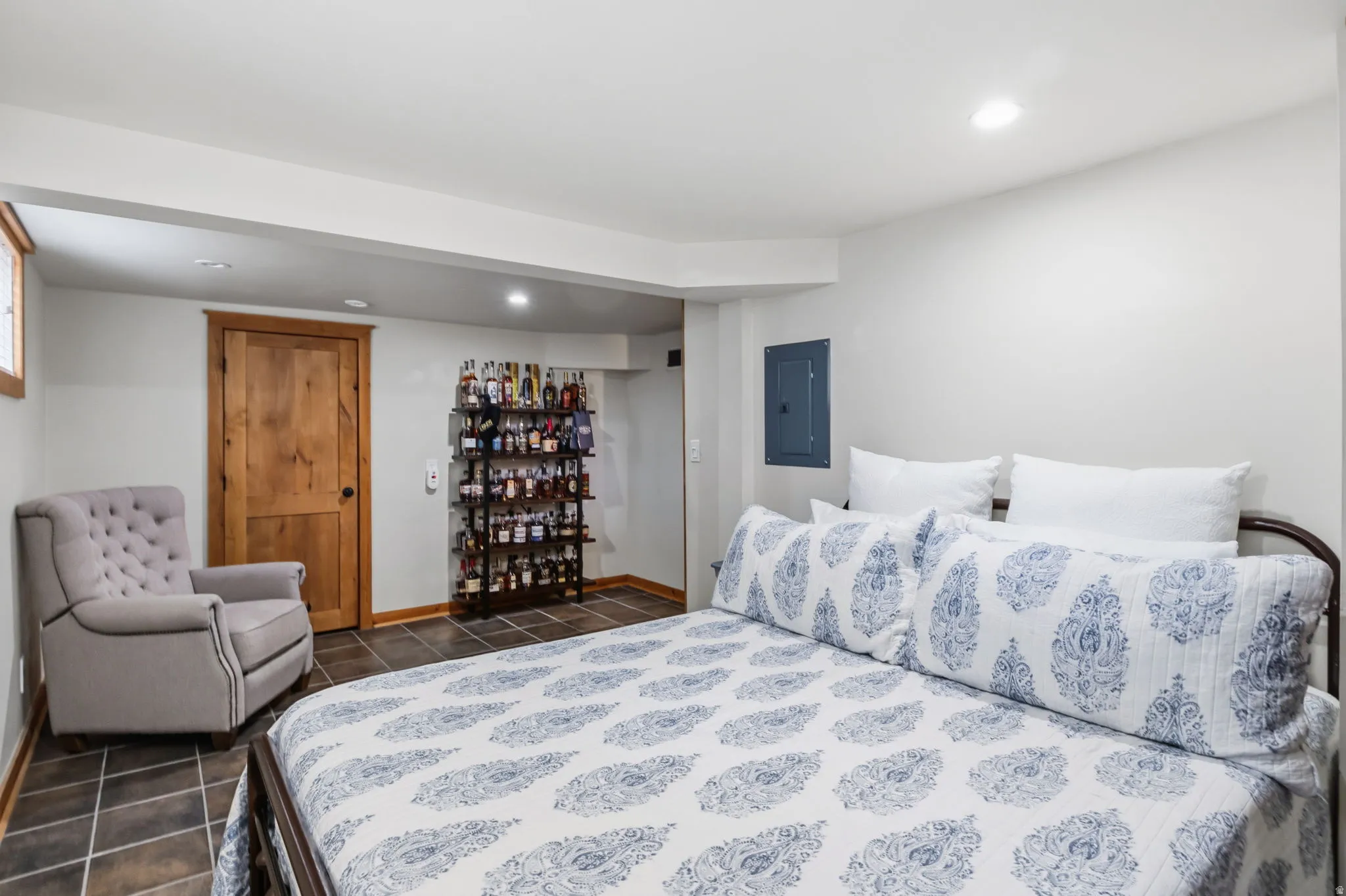 Recessed ceiling lighting, wood-finish interior door, and tile flooring