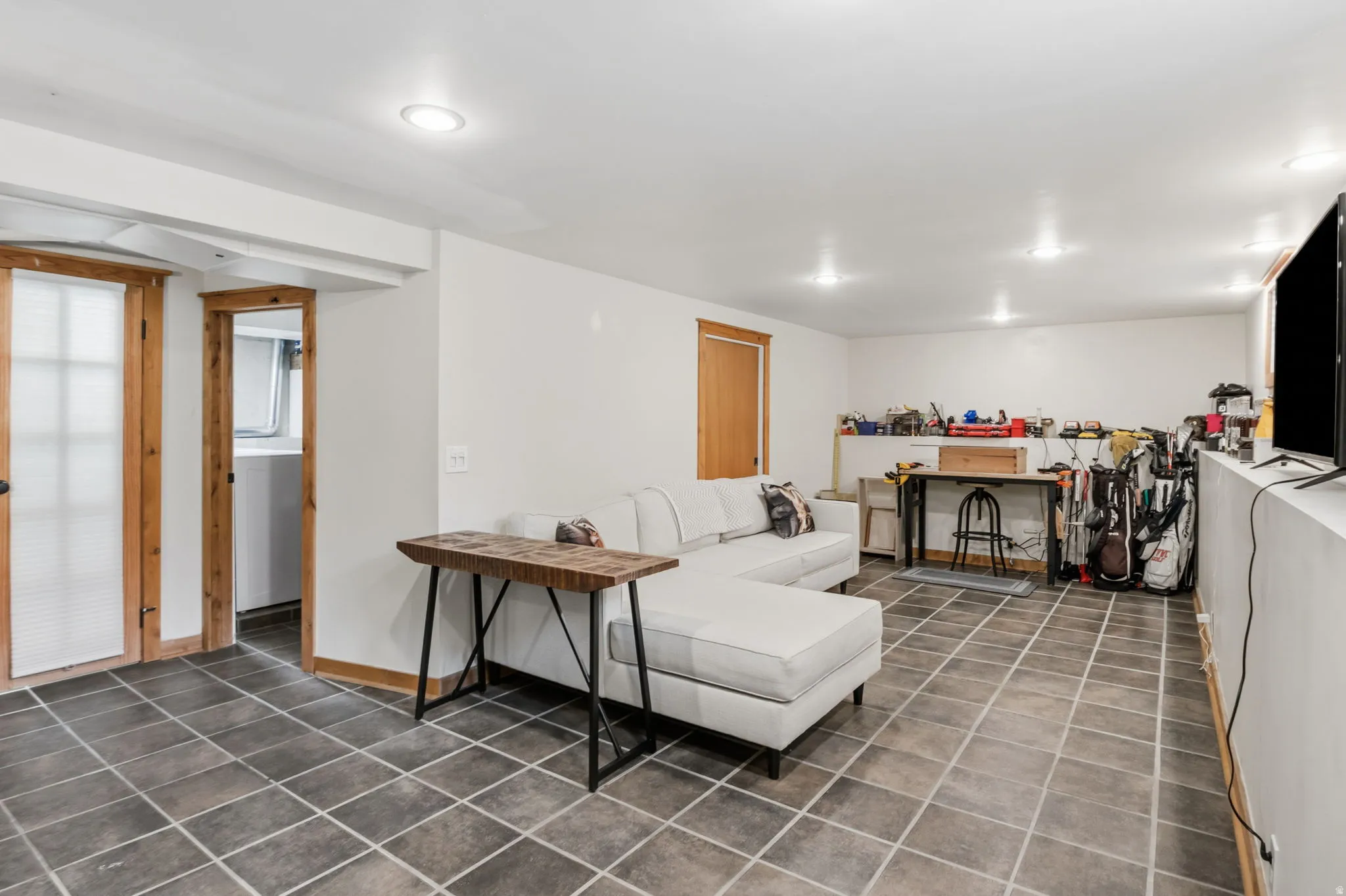Great living room w/Recessed lighting illuminates this space featuring tile flooring and natural wood trim accents