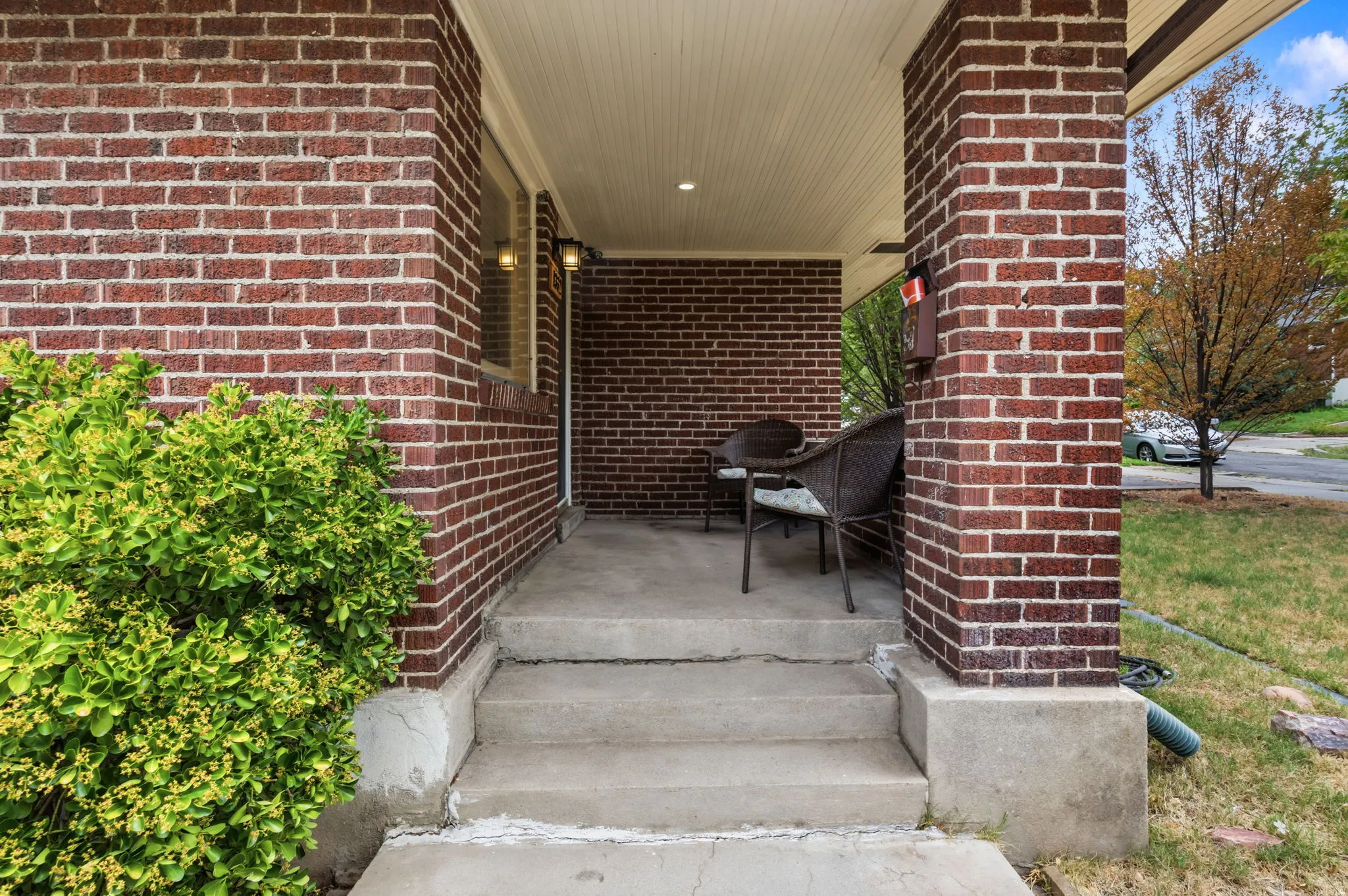 Brick exterior with concrete porch and steps