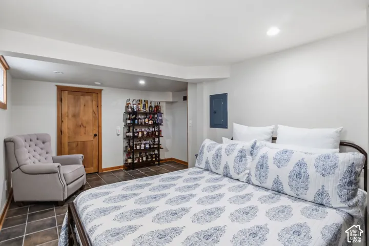 Recessed ceiling lighting, wood-finish interior door, and tile flooring
