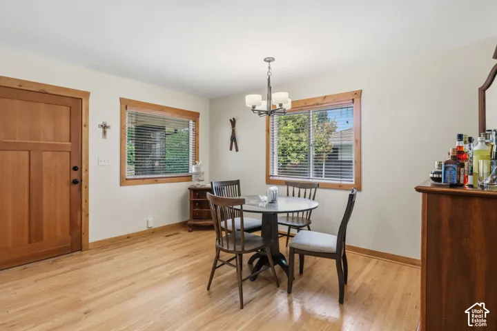 Wood-finish flooring throughout, light-toned walls, and wood-framed windows with blinds