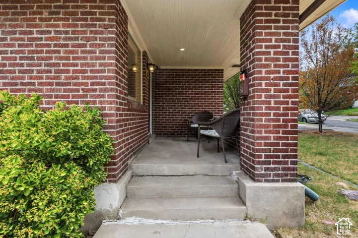 Brick exterior with concrete porch and steps