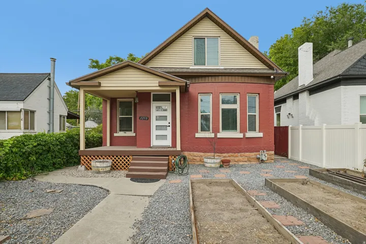 Two-story residence with red brick and horizontal siding