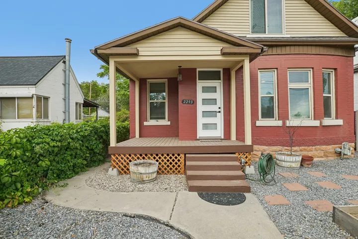 Covered front porch with wood-finish decking and lattice detailing