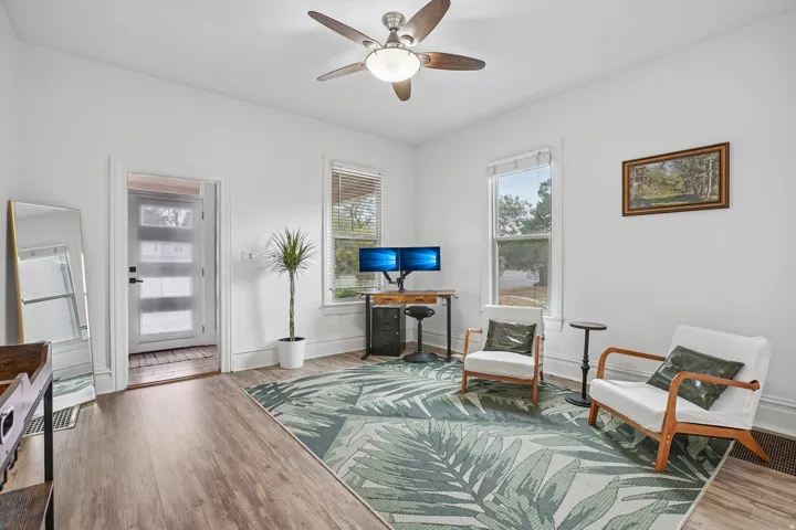 Entryway with a modern paneled glass door and wood-finish flooring