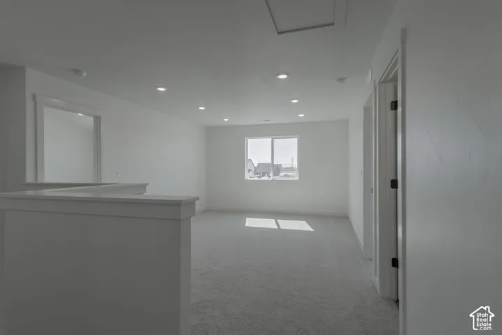 Recessed lighting, light gray carpet, white walls, and white trim