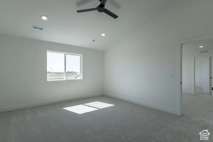 Recessed lighting, ceiling fan, carpeting, and a window with a rural backdrop