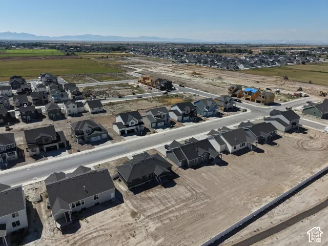 Newly constructed residential community featuring a variety of architectural styles, paved streets, and mountain backdrops
