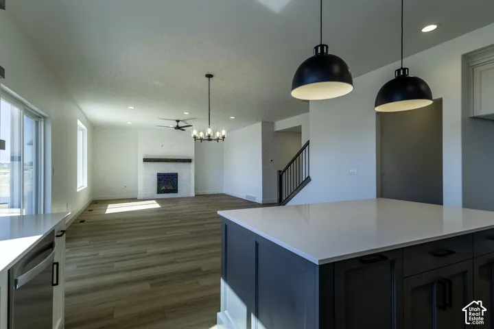 Modern kitchen island with a light-toned countertop and pendant lighting