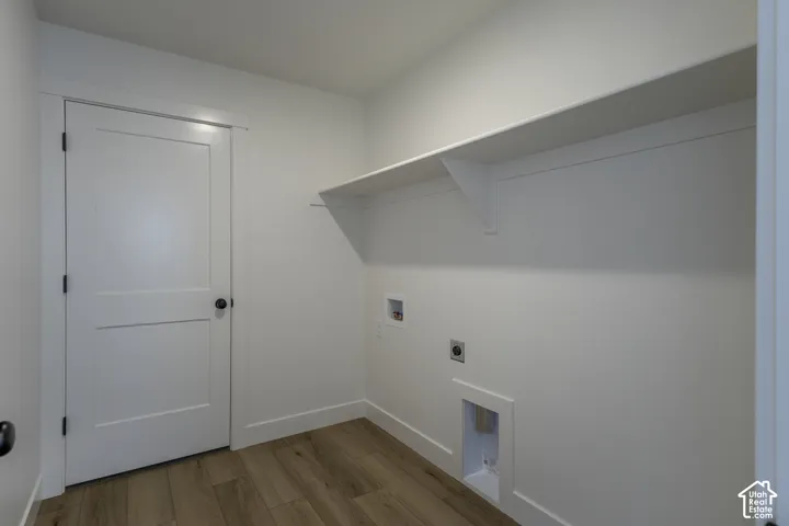 Wood-finish flooring, white walls, and a built-in storage shelf