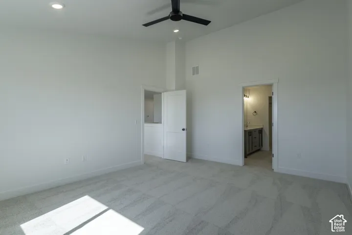 Vaulted ceiling with a ceiling fan, recessed lighting, and soft carpet flooring