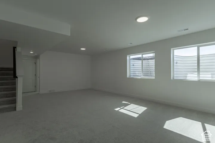 Bright, open room flooded with natural light through dual casement windows