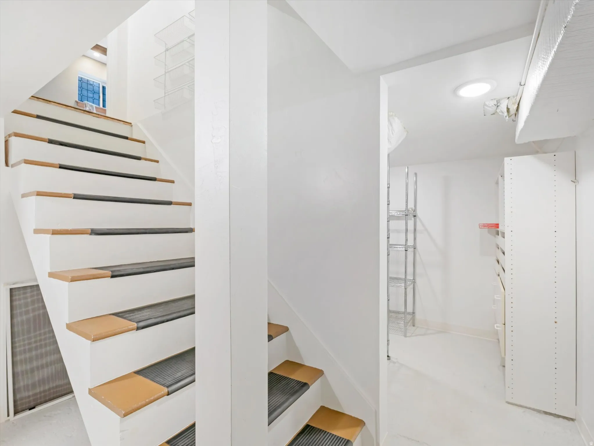 White painted staircase with wood-finish treads and risers