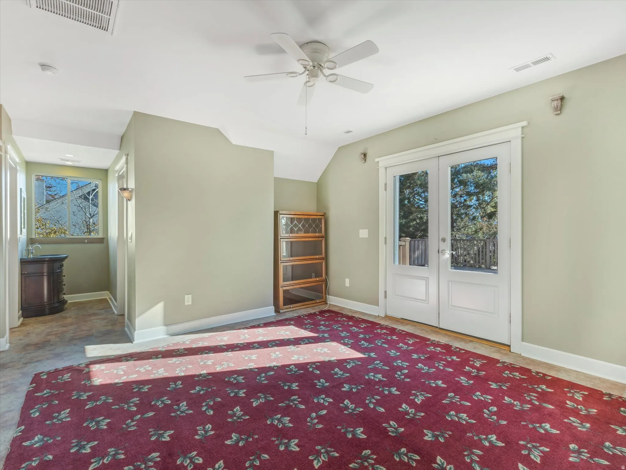 Entrance to the brand new deck, double glass-paneled doors, wood-finish flooring, and built-in vanity with vessel sink