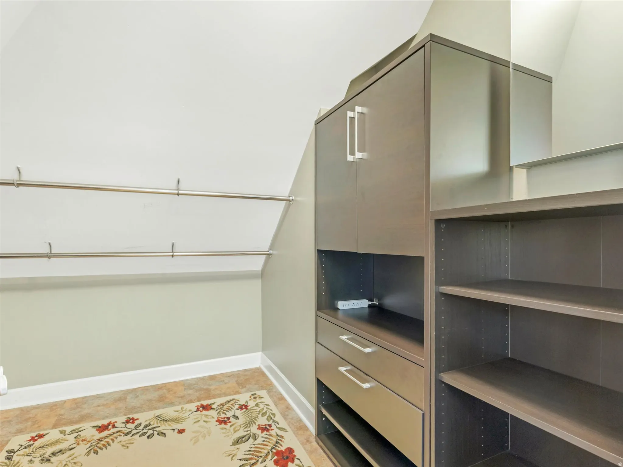 Walk-in closet, with built-in cabinetry with silver-tone hardware, adjustable shelving, and garment rods